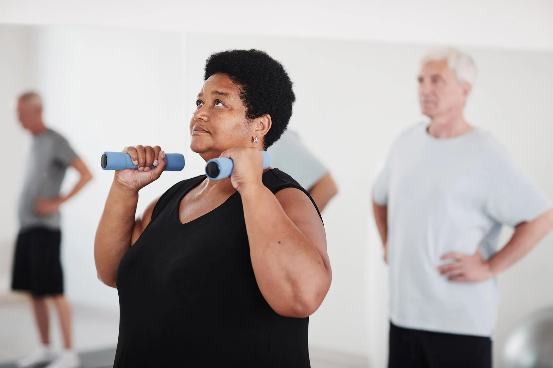 Woman lifting dumbbells during training